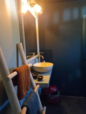 a bathroom with a sink and a bowl on a table at Dilectus (Via Caput) in Lokeren