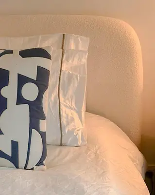 a pillow sitting on top of a bed at Kleurrijke nieuwe woonst in hartje Antwerpen in Antwerp