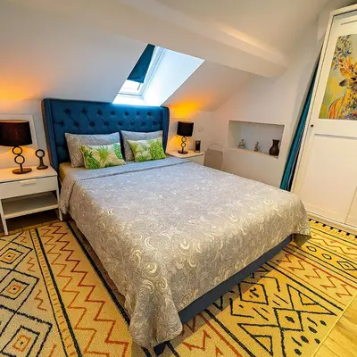 a bedroom with a large bed with a blue headboard at Brussels Sanctuary Appartment in Brussels