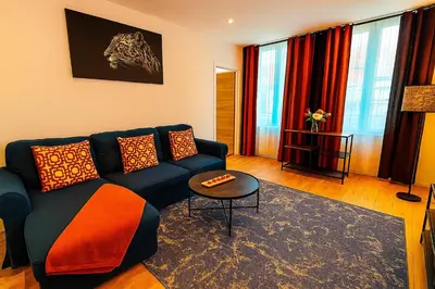 a living room with a blue couch and a table at Brussels Sanctuary Appartment in Brussels
