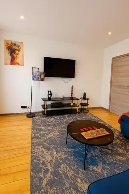 a living room with a tv and a coffee table at Brussels Sanctuary Appartment in Brussels