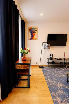 a living room with a table and a tv at Brussels Sanctuary Appartment in Brussels