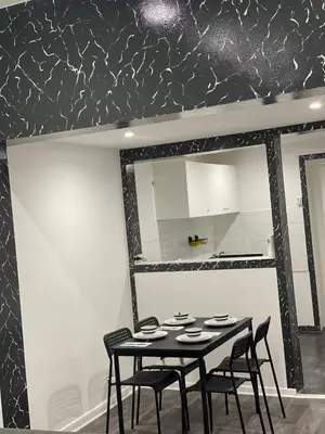 a dining room with a table and chairs and a mirror at Appartement au cœur de Bruxelles in Brussels