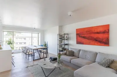 a living room with a couch and a table at Classy flat with awesome view and great location! in Antwerp