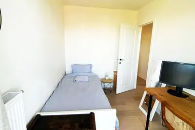 a small bedroom with a bed and a flat screen tv at Classy flat with awesome view and great location! in Antwerp