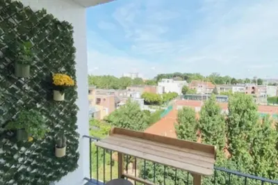 a balcony with a bench and a view of a city at Classy flat with awesome view and great location! in Antwerp
