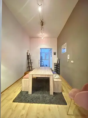 a living room with a table in the middle of a room at Family Stays Flagey in Brussels