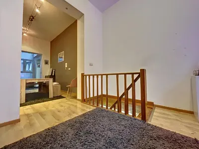 a living room with a staircase and a desk at Family Stays Flagey in Brussels
