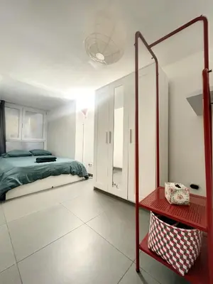 a bedroom with a bed and a red shelf at Family Stays Flagey in Brussels
