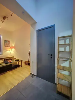 a room with a door and a desk and a ladder at Family Stays Flagey in Brussels