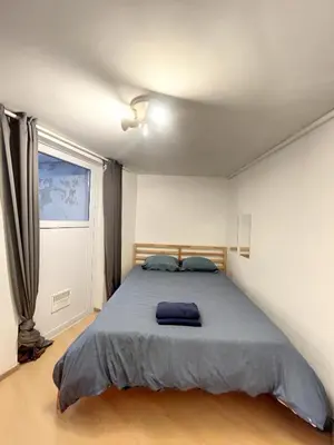 a bedroom with a bed with a blue blanket at Family Stays Flagey in Brussels