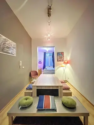 a room with a table with pillows on it at Family Stays Flagey in Brussels