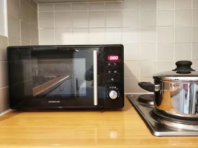 a microwave sitting on a counter next to a stove at Cosy apartement in Antwerp's hipster neighbourhood in Antwerp