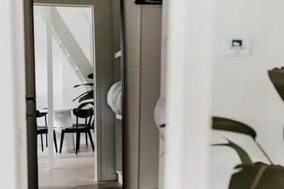a hallway with a door leading to a dining room at Cathedral view from the bathtub in Antwerp