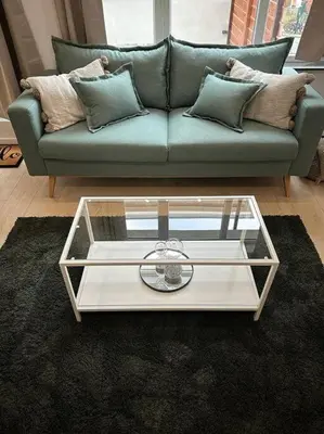 a living room with a couch and a glass coffee table at Magnifique duplex in Brussels