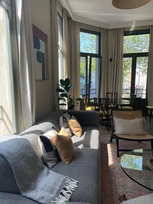 a living room with a gray couch with pillows at Stunning apartment by MAS in Antwerp