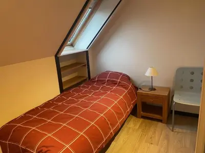 a small bedroom with a bed and a window at Ahwell Guesthouse Gent 5 BR long term in Laarne