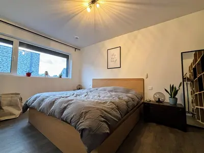 a bedroom with a bed and two lights on the ceiling at Maison Seigneur in Asse
