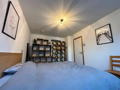a bedroom with a bed and a shelf of wine barrels at Maison Seigneur in Asse