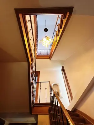 a staircase with a window and a chandelier at CES Home in Ghent