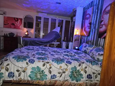 a bedroom with a bed with a floral comforter at Love Zen Room Atomium et Palais de l'exposition in Brussels