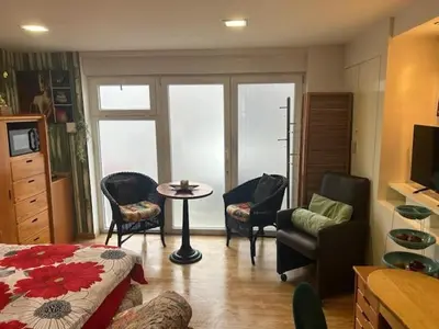 a living room with a couch and a table and chairs at Love Zen Room Atomium et Palais de l'exposition in Brussels