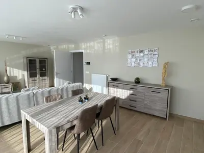 a living room with a table and a couch at Residentie Sluispark in Ghent