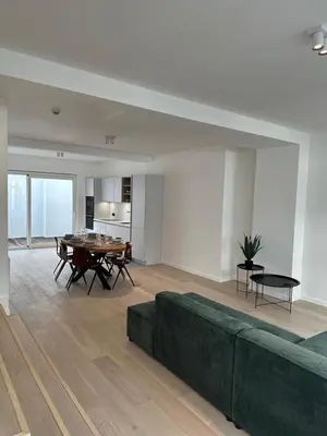 a living room with a couch and a table at Märch - Mechelen Goat 6 in Mechelen