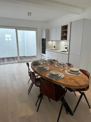 a dining room with a table with plates and wine glasses at Märch - Mechelen Goat 6 in Mechelen