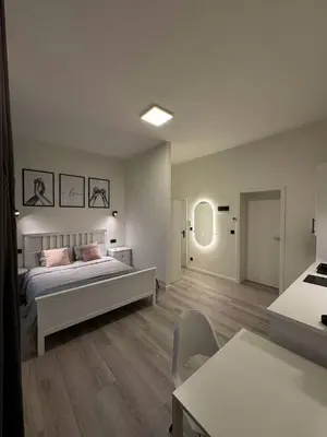 a bedroom with a bed and a table and chairs at Studio à Ixelles - Viaduc in Brussels