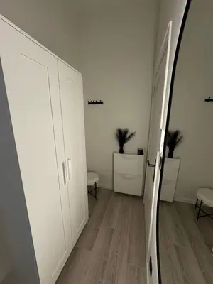 a room with a hallway with white walls and a mirror at Studio à Ixelles - Viaduc in Brussels