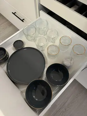 a counter with black plates and glasses on it at Studio à Ixelles - Viaduc in Brussels