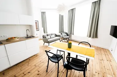 a kitchen and living room with a table and chairs at FLATS aparthotel in Brussels