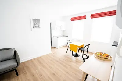 a living room with a table and chairs at FLATS aparthotel in Brussels