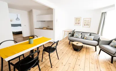 a living room with a table and chairs and a couch at FLATS aparthotel in Brussels