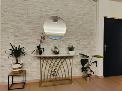 a mirror on a wall with plants on it at Bright & Cozy Appartment in Brussels in Brussels