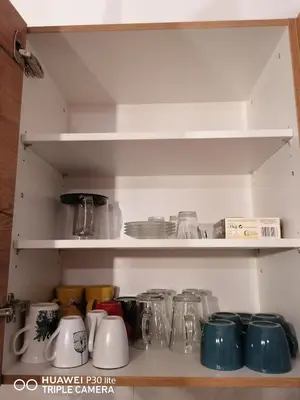 a shelf filled with glass jars and other items at Bright & Cozy Appartment in Brussels in Brussels