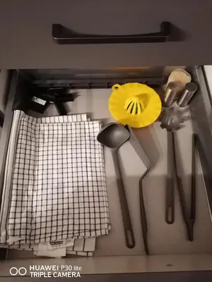 a kitchen counter with utensils on top of it at Bright & Cozy Appartment in Brussels in Brussels