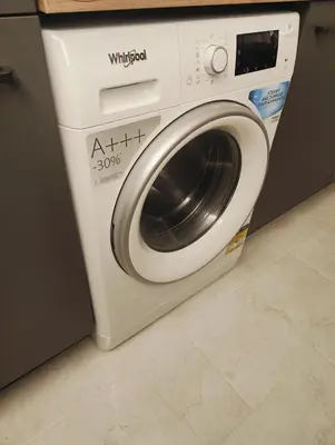 a white washing machine sitting in a kitchen at Bright & Cozy Appartment in Brussels in Brussels