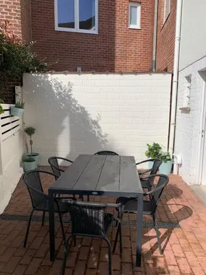a black table and chairs on a patio at Une belle étage à Stockel with charming patio in Brussels
