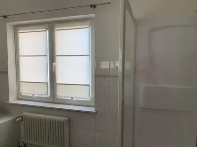 a bathroom with a window and a radiator at Une belle étage à Stockel with charming patio in Brussels