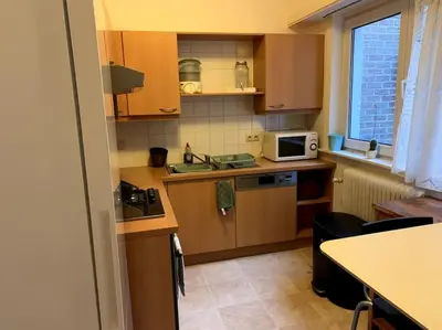 a small kitchen with a sink and a microwave at Une belle étage à Stockel with charming patio in Brussels