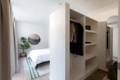 a bedroom with a bed and a closet at Cathedral view apartment in Antwerp