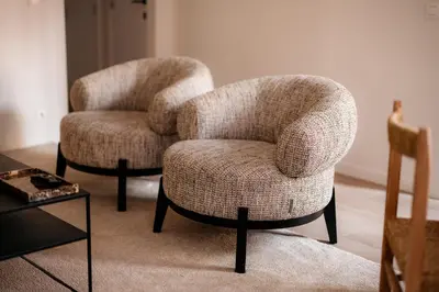 two chairs and a table in a living room at Cathedral view apartment in Antwerp