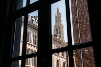 a window view of a building with a clock tower at Cathedral view apartment in Antwerp
