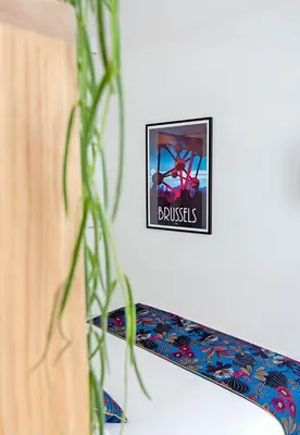 a picture of a sign on a wall with a plant at Happy Boutique Hotel - Grand Place in Brussels
