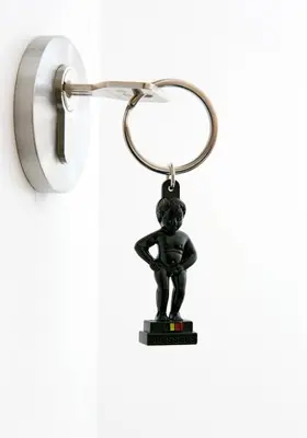a small figurine of a person hanging on a key chain at Happy Boutique Hotel - Grand Place in Brussels