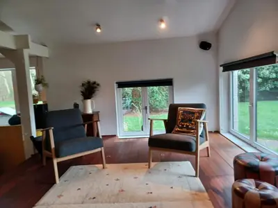 a living room with two chairs and a table at De Vijver in Geel