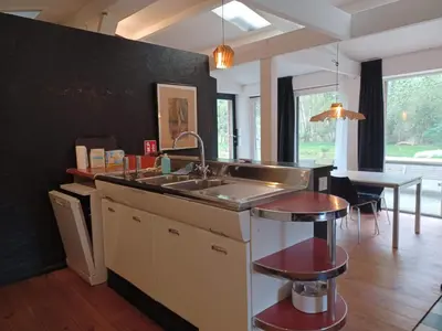 a kitchen with a sink and a counter top at De Vijver in Geel