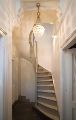 a staircase in a house with a chandelier at Holiday Home Amélie in Antwerp